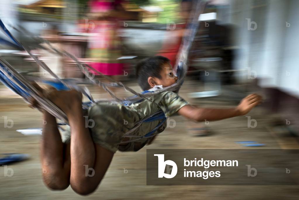 Khmu boy playing near Luang Prabang, Laos (photo)