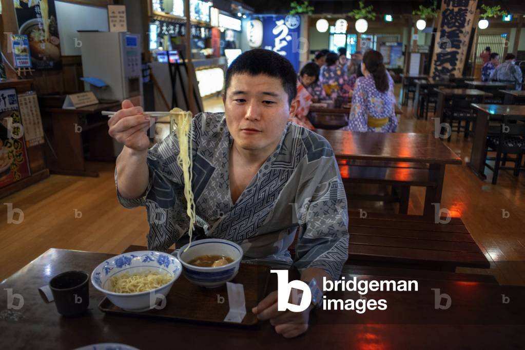 Local people eating at the Oedo Onsen Monogatari restaurant a 24 hour onsen, Tokyo, Japan, March 2020 (photo)