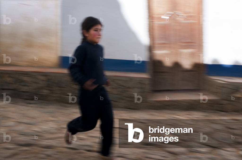 Girl running Los Nevados village in andean cordillera Merida state Venezuela (photo)