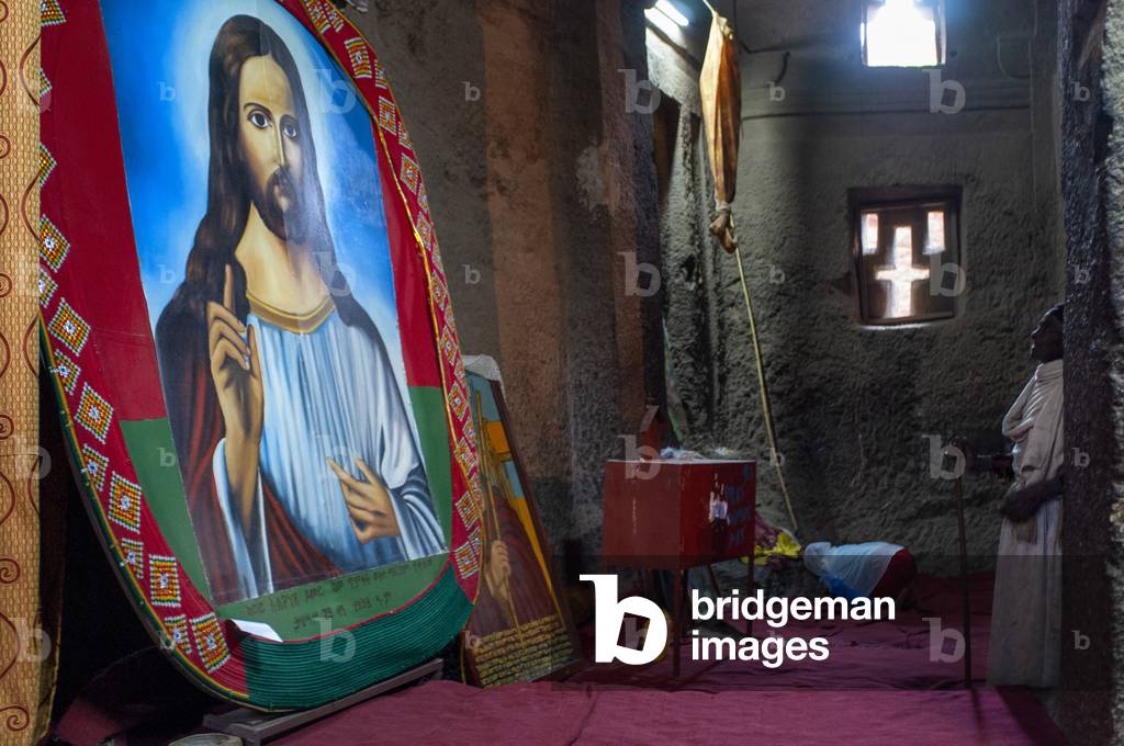 Lalibela, Amhara region, Ethiopia, A man prays inside the church Bet Medhane Alem (photo)