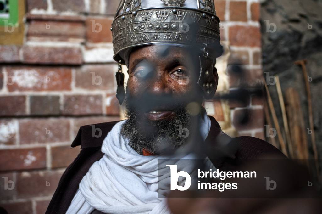Portrait of an ethiopian orthodox priest holding a cross in nakuto lab cave church, Amhara region, Lalibela, Ethiopia (photo)