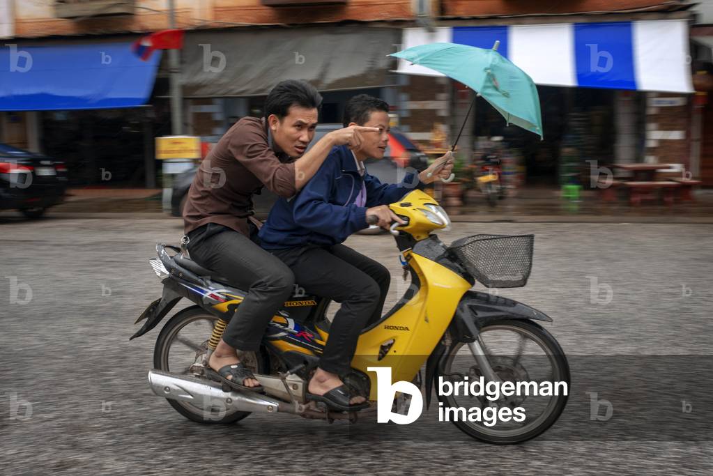Motorbike on main street in Luang Prabang, Laos (photo)