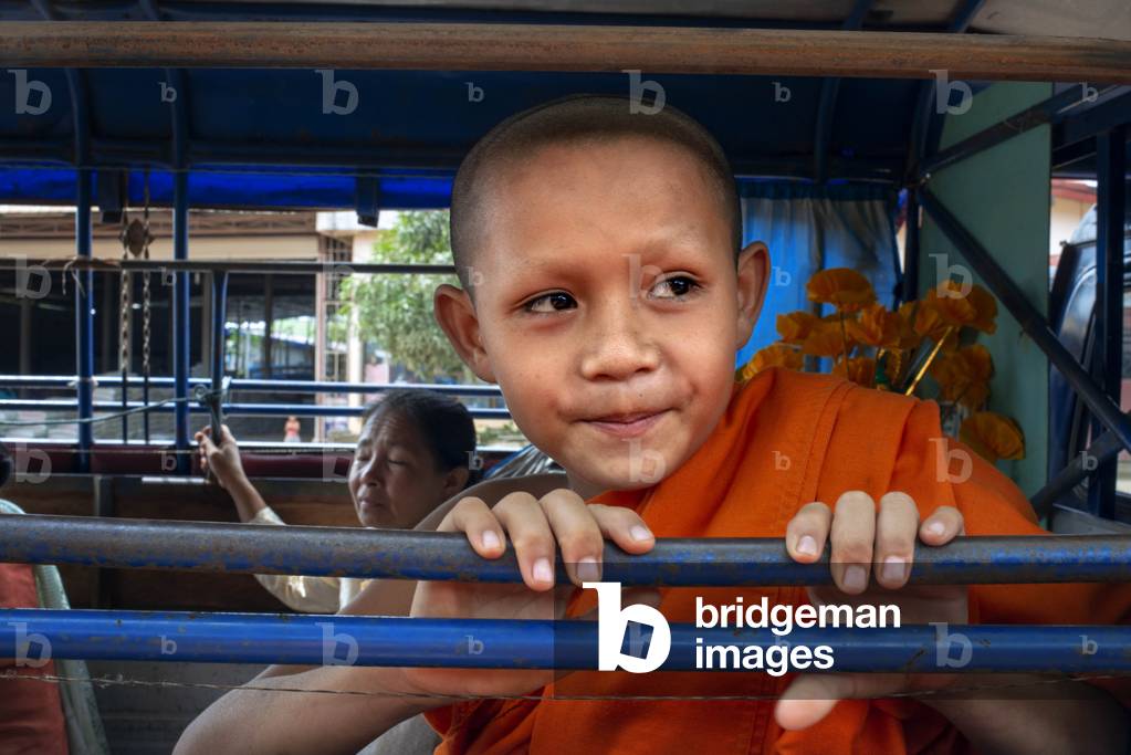 Young monks travel through Luang Prabang in a tuk tuk, Laos (photo)