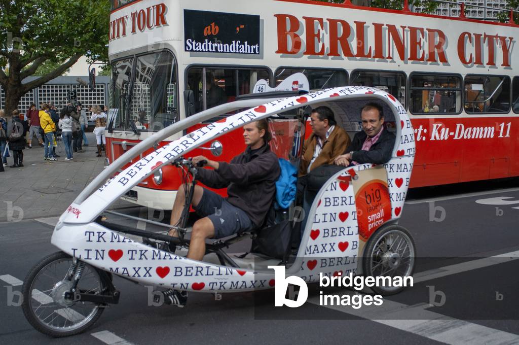 Sightseeing tour bus and Eco-friendly Tricycle taxi or Pedicab in, Berlin, Germany (photo)