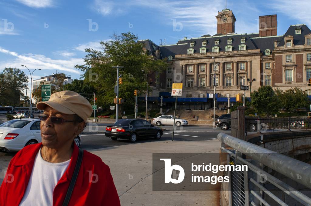 Local black people and low angle view of the landmarked Staten Island Borough Hall on Richmond Avenue Terrace, St. George, Staten Island, New York City, USA (photo)