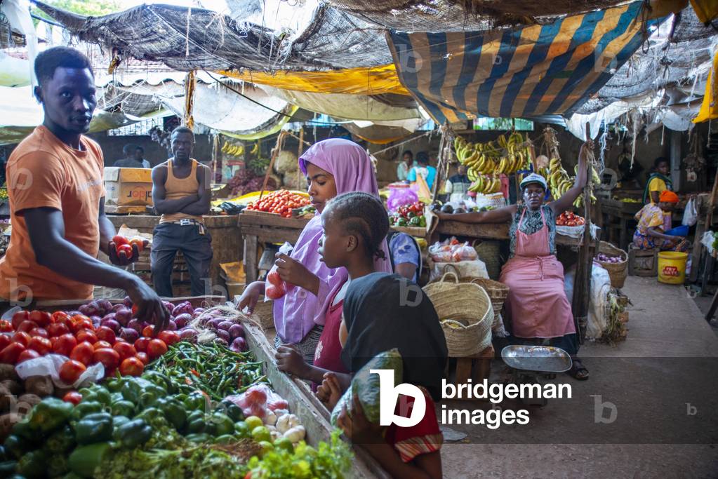 Man selling vegetables in the market, Lamu town, Lamu Archipelago, Kenya, 2020 (photo)