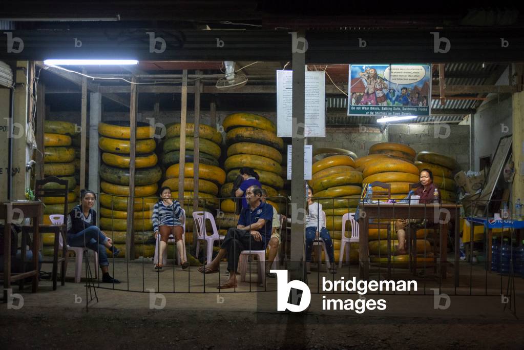 Piles of coloured tubes inner tyres used for tubing along the river in Vang Vieng, Laos (photo)