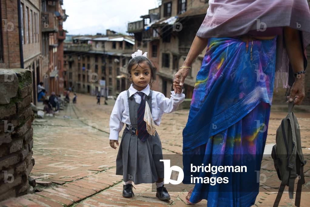 A mother taking her daughter to school, Bhaktapur, Kathmandu Valley, Nepal (photo)