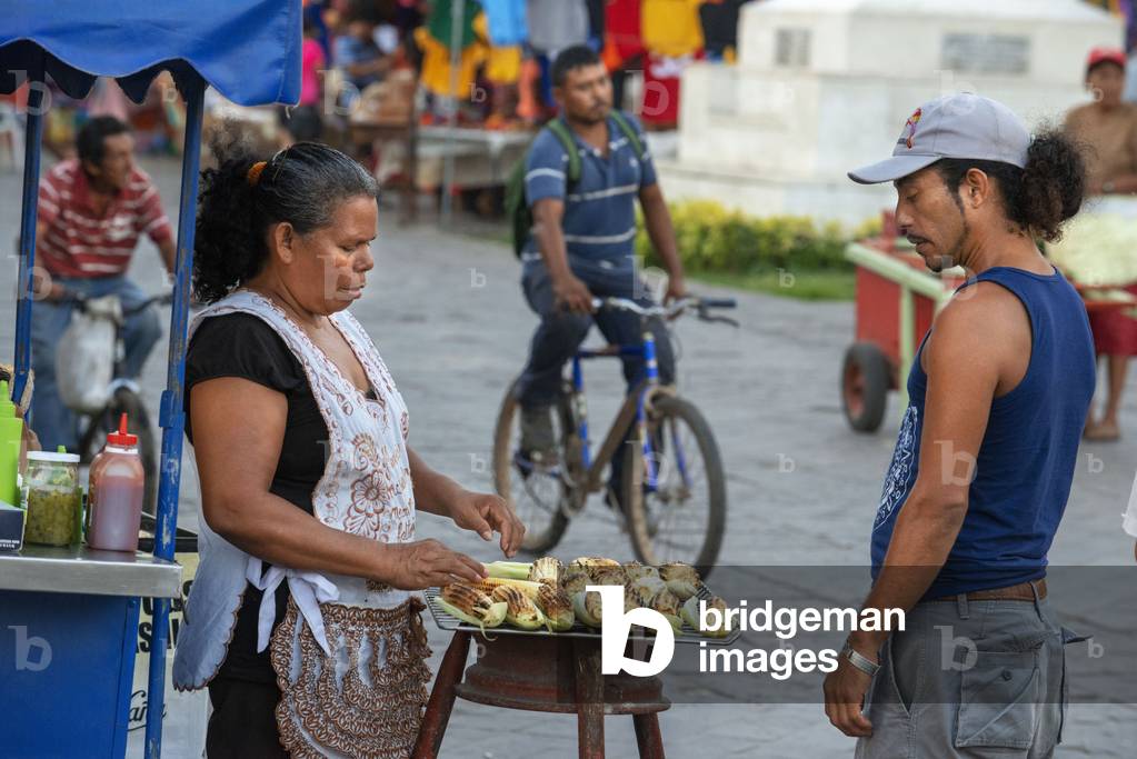 Local woman selling roasted corn cob stall in the colonial city of Granada Nicaragua, Central America, America (photo)