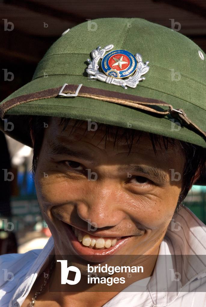 Smiling Vietnamese man wearing a Vietnamese helmet, portrait, Dien Bien Phu, Vietnam, Asia (photo)