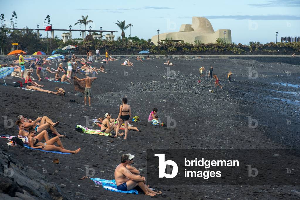 Tourists at los gigantes cliffs volcanic black sand beach in Puerto de la Cruz, Tenerife Island, Canary Islands, Spain (photo)
