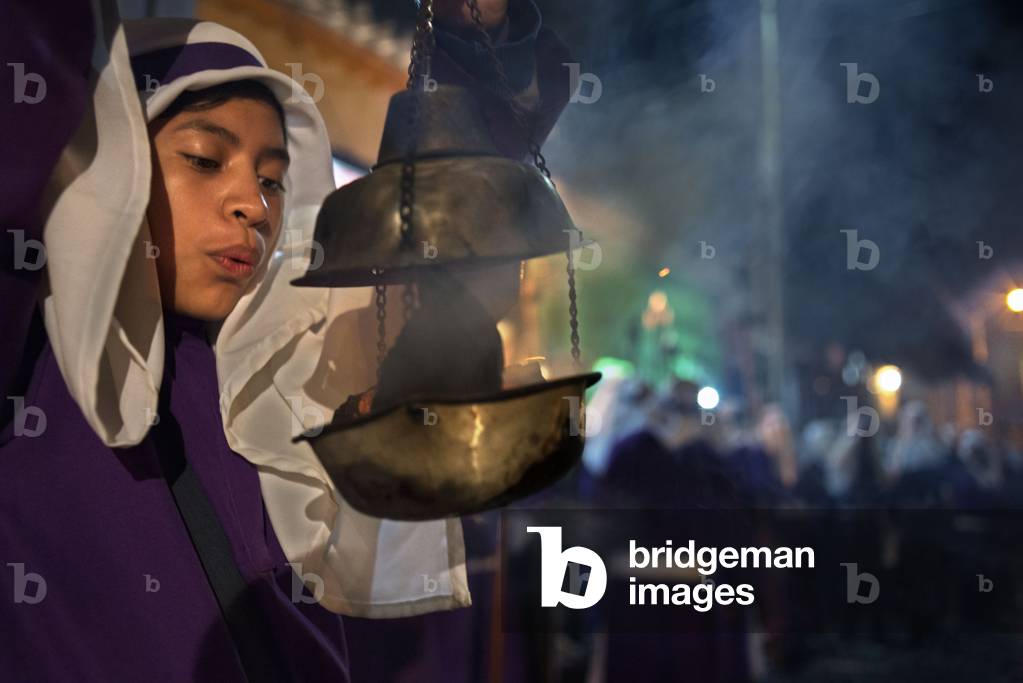 A boy spreads incense at the Jesus Nazareno del Perdon procession during Easter Holy Week in Antigua Guatemala, 2020 (photo)