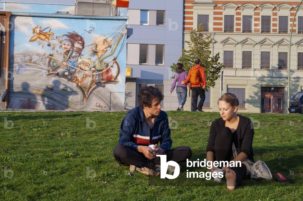Graffiti on original section of Berlin Wall at the East Side Gallery in Friedrichshain Berlin, Germany (photo)