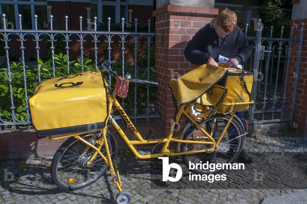 Deutsche Post, German postal company, postman on bike, Kreuzberg, west Berlin, Germany (photo)