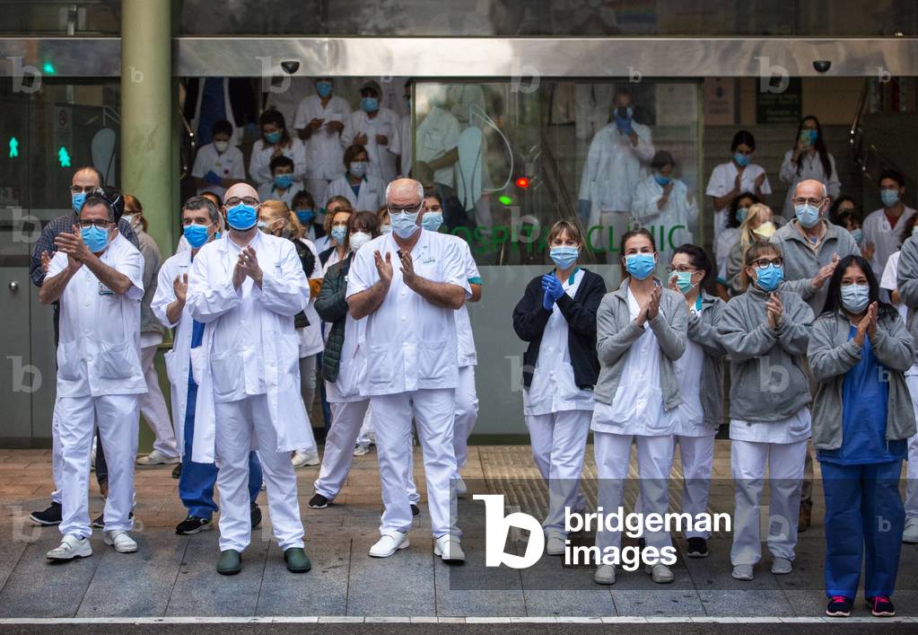 A group of doctors and health personnel from the Hospital clinic applauding those that show gratitude towards them during the coronavirus crisis, Barcelona, Spain, 9th April 2020 (photo)