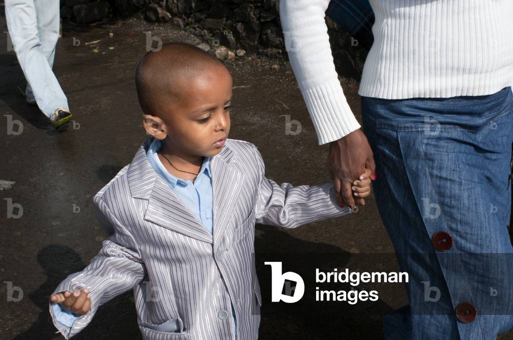 Sunday dress boy and Street scene in Gondar city, Ethiopia (photo)