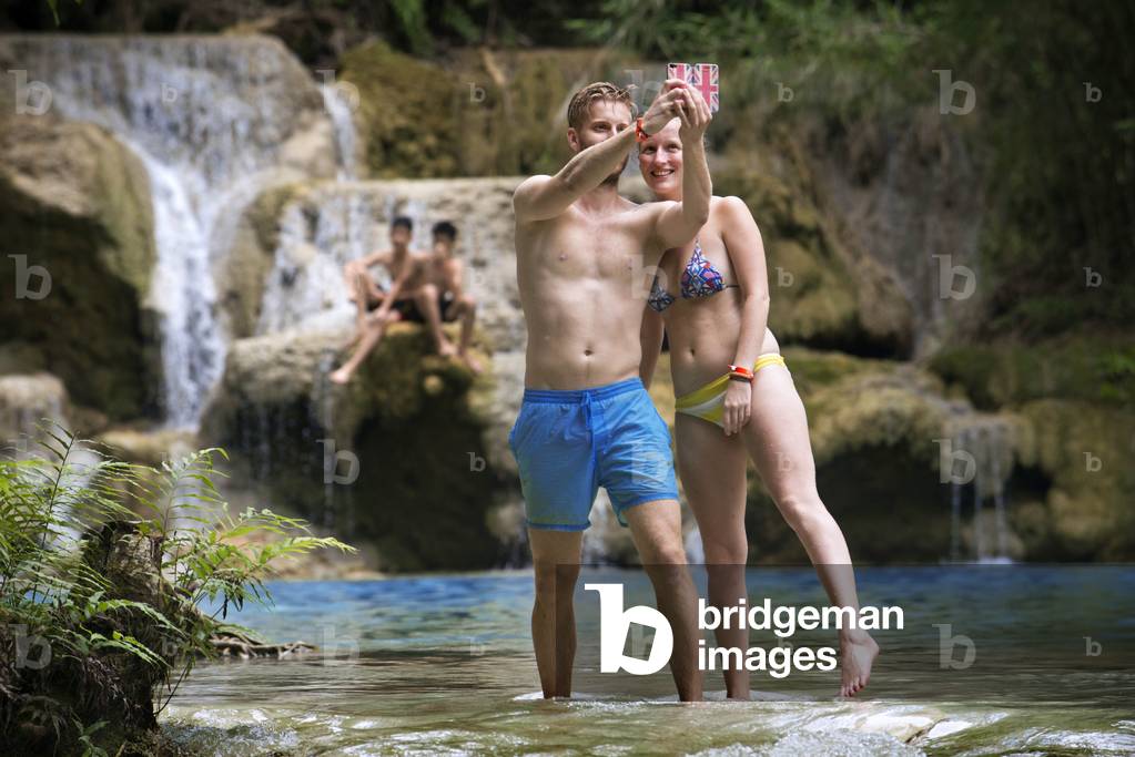 Tourists at the Waterfalls at the Tat Kuang near Luang Prabang in, Laos (photo)