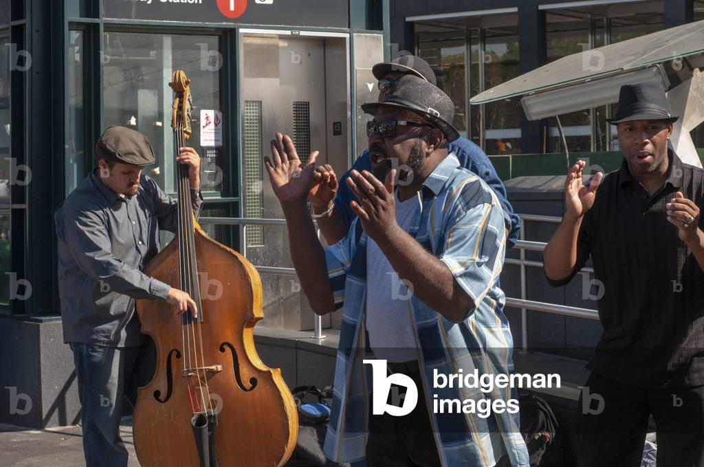 A street musician black people playing music in South Ferry Subway Station Manhattan New York City, USA (photo)