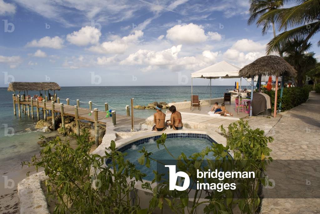 Tourists at swimming pool and spa of Hotel Compass Point Resort at Love beach Nassau, Bahamas, Caribbean (photo)