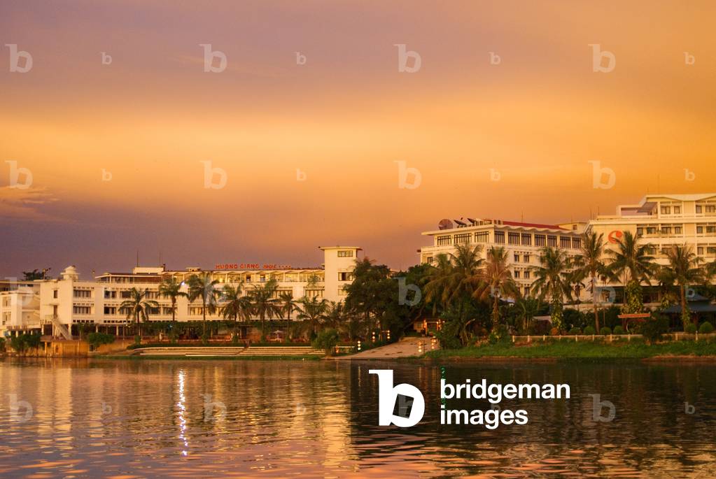 River front hotels, Dragon boat cuises at sunset on the river Huong (Perfume River), Vietnam (photo)