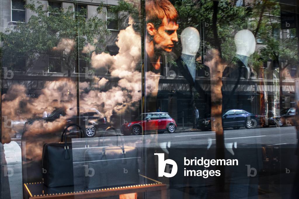 Reflection in a window of a fashion store on the Upper East Side, New York City, USA (photo)