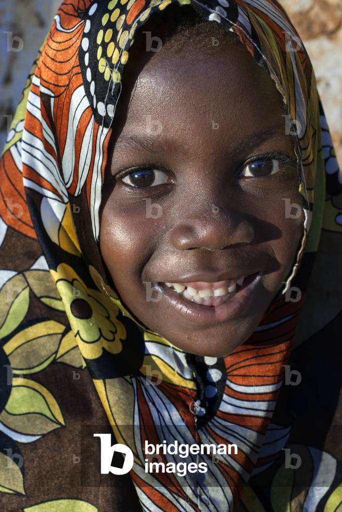 Young girl dressed with full color clothing in Kizimkazi Dimbani village, West coast, Zanzibar, Tanzania, Africa (photo)