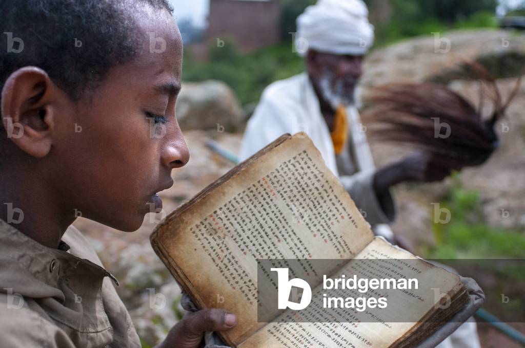 Lalibela, Amhara region, Ethiopia, A child prays in one of the Lalibela churches (photo)