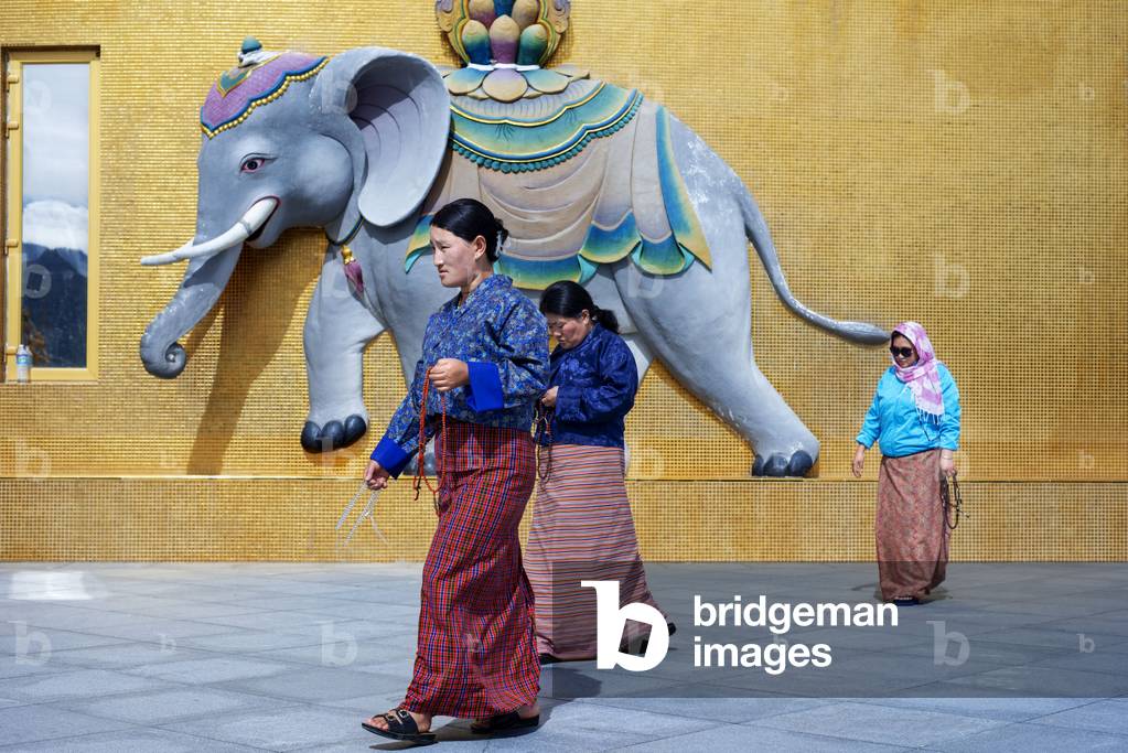 Buddhist praying at the Buddha Dordenma statue, Kuenselphodrang Nature Park, Bhutan, 2021 (photo)