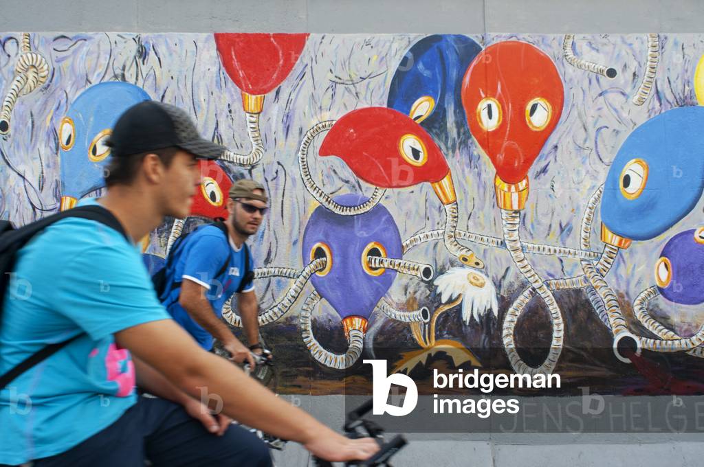 Graffiti on original section of Berlin Wall at the East Side Gallery in Friedrichshain Berlin, Germany (photo)