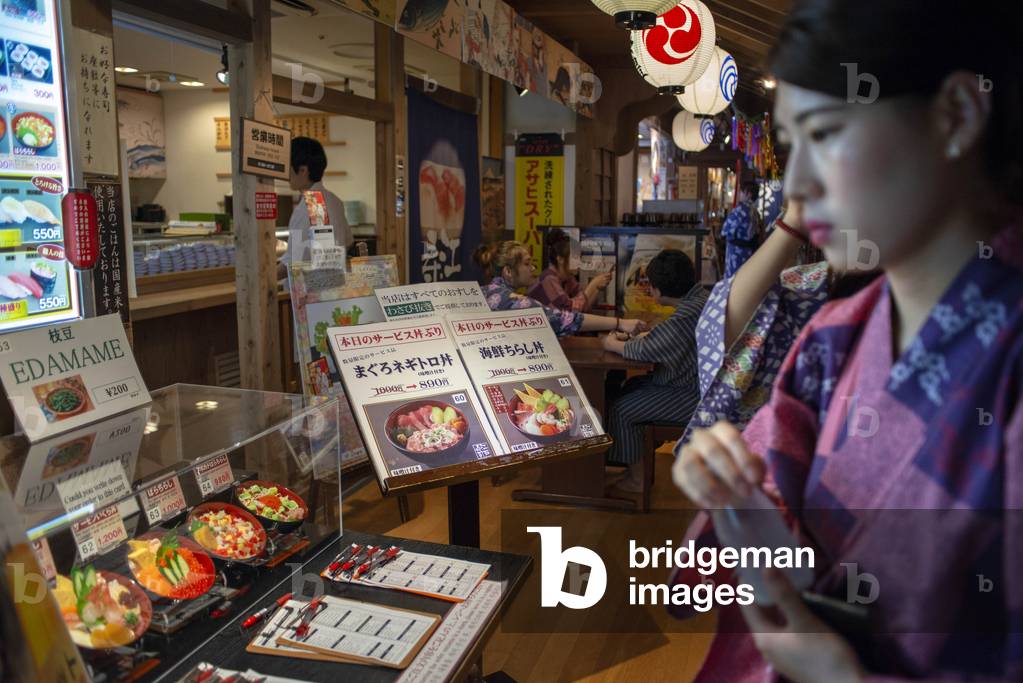 Local people eating at the Oedo Onsen Monogatari restaurant a 24 hour onsen, Tokyo, Japan, March 2020 (photo)