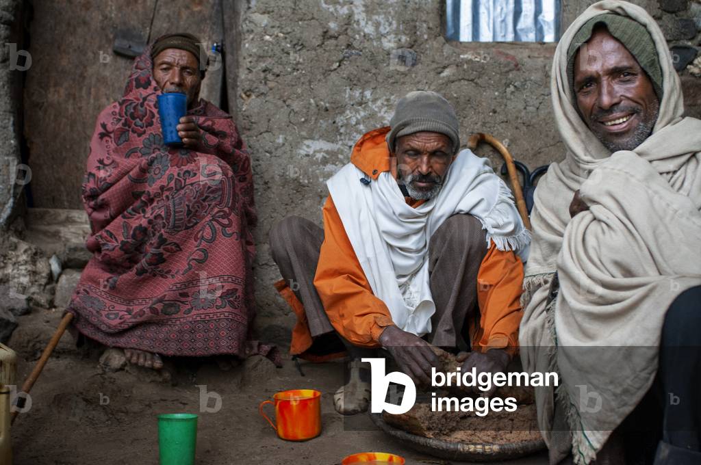 Local people sharing food in nakuto lab cave church, Amhara region, Lalibela, Ethiopia (photo)