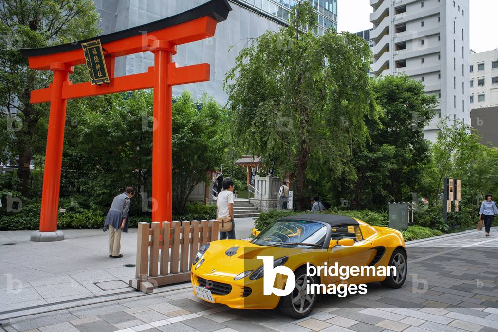 Fashion and futuristic yellow car parked on COREDO Muromachi small temple, Tokyo, Japan, March 2020 (photo)