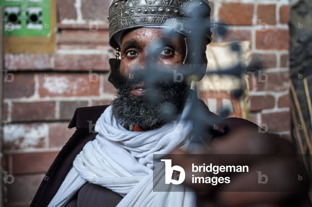 Portrait of an ethiopian orthodox priest holding a cross in nakuto lab cave church, Amhara region, Lalibela, Ethiopia (photo)