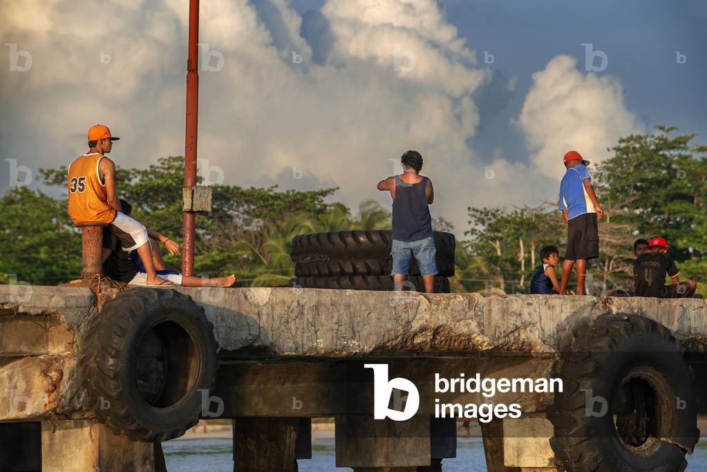 Local fishers in a pier in the coast of Corn Island, Caribbean Sea, Nicaragua, Central America, America (photo)
