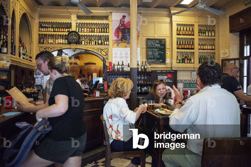 Typical tapas bar food Casa Morales with its wine tanks. Santa Cruz district, Sevilla, Andalucia, Spain (photo)