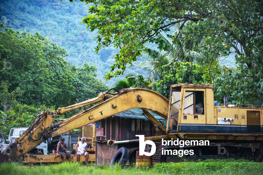 Automotive graveyard, car cemetery yard, abandoned car junkyard under trees Moorea, French Polynesia, Society Islands, South Pacific, Ecological problems, 2020 (photo)