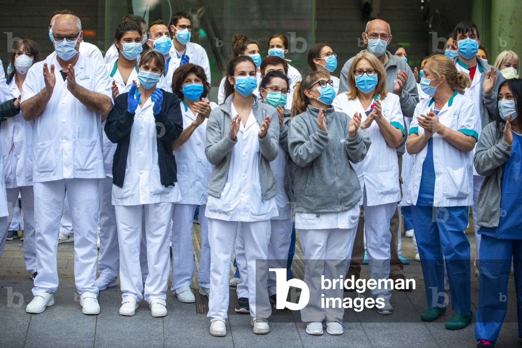 A group of doctors and health personnel from the Hospital clinic applauding those that show gratitude towards them during the coronavirus crisis, Barcelona, Spain, 9th April 2020 (photo)