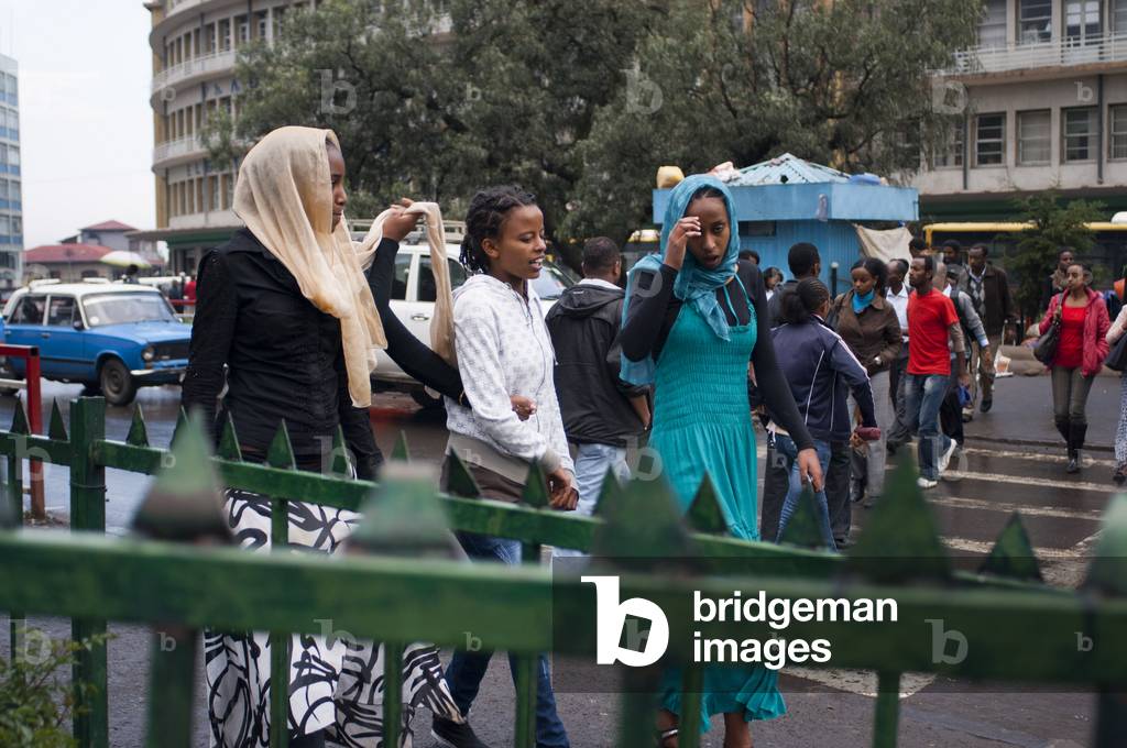 Woman walking in a busy intersection in the city center Addis Ababa, Ethiopia (photo)