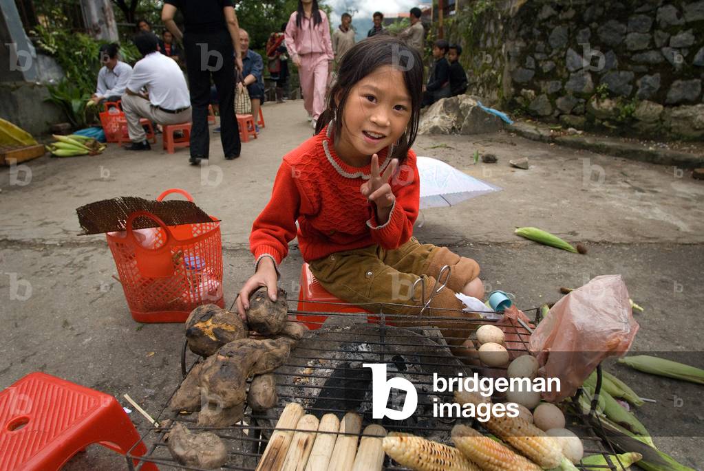 Girl of Ethnic Hmong tribe, selling food in the street, Sapa, Vietnam (photo)