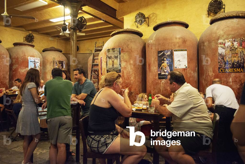 Typical tapas bar food Casa Morales with its wine tanks. Santa Cruz district, Sevilla, Andalucia, Spain (photo)