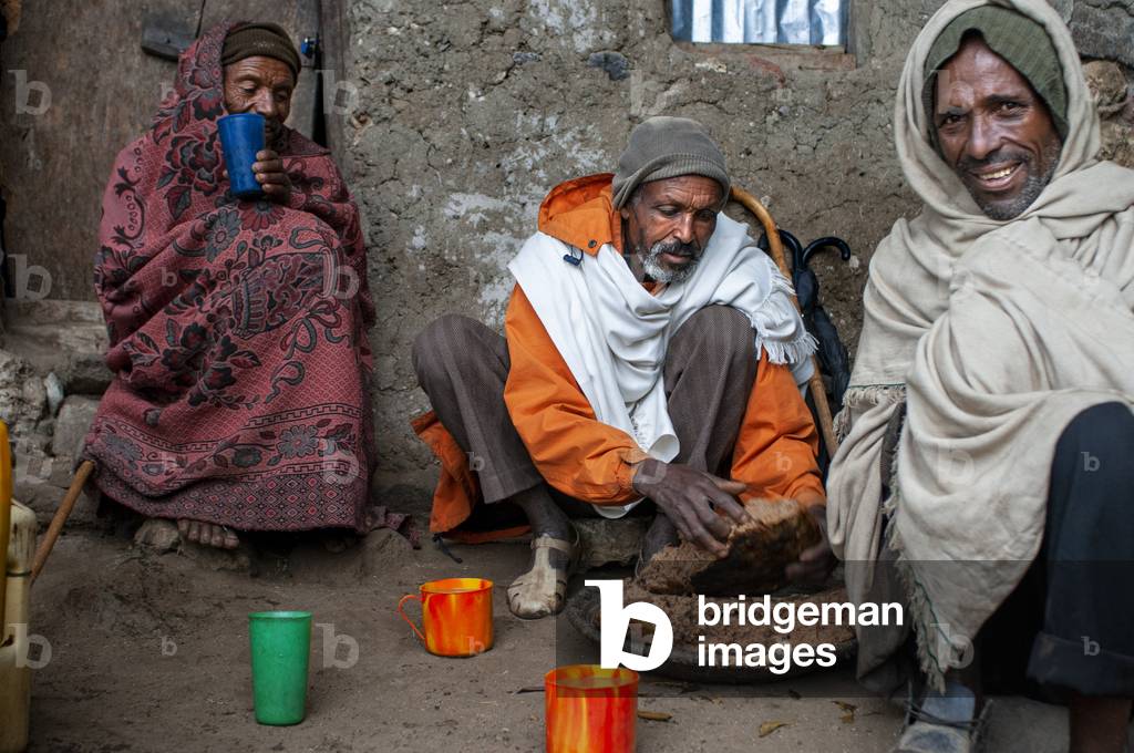 Local people sharing food in nakuto lab cave church, Amhara region, Lalibela, Ethiopia (photo)