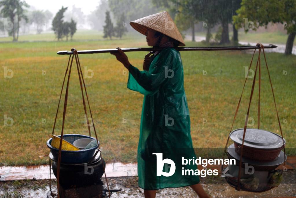 Monsoon rains in the city of Hue, People iwalking along flooded streets in Hue, Vietnam (photo)