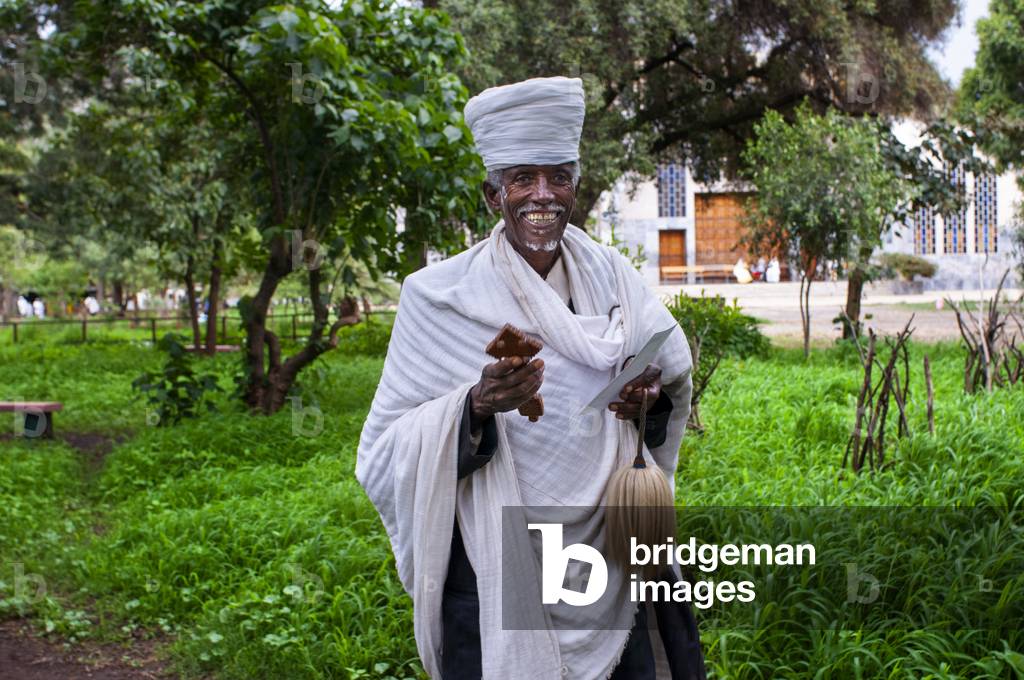 St Mary of Zion church, Aksum, Ethiopia, A devout Christian Coptic prays outside the church of St Mary of Zion in Axum, the place where they believe the Ark of the Covenant is kept (photo)