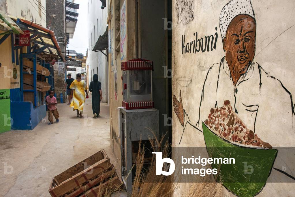 Local people in the narrow strees of the city town of Lamu island in Kenya, 2020 (photo)