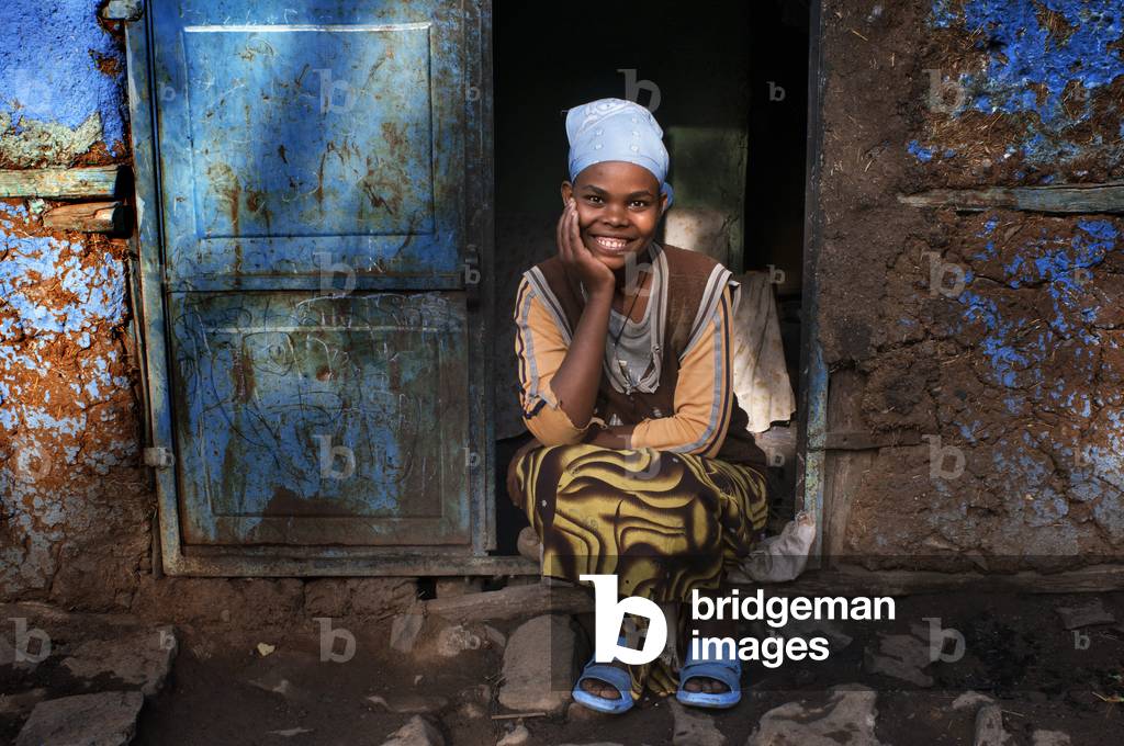Woman outside of one of the oldest houses in the city of Gondar, Ethiopia (photo)
