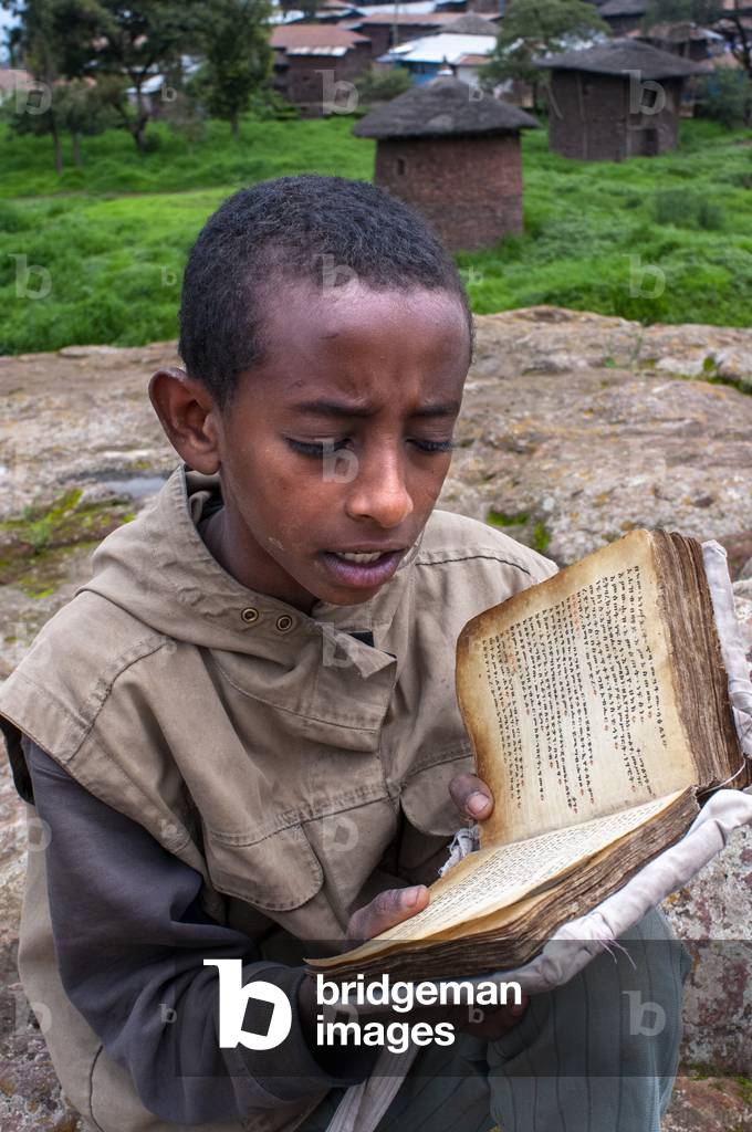 Lalibela, Amhara region, Ethiopia, A child prays in one of the Lalibela churches (photo)