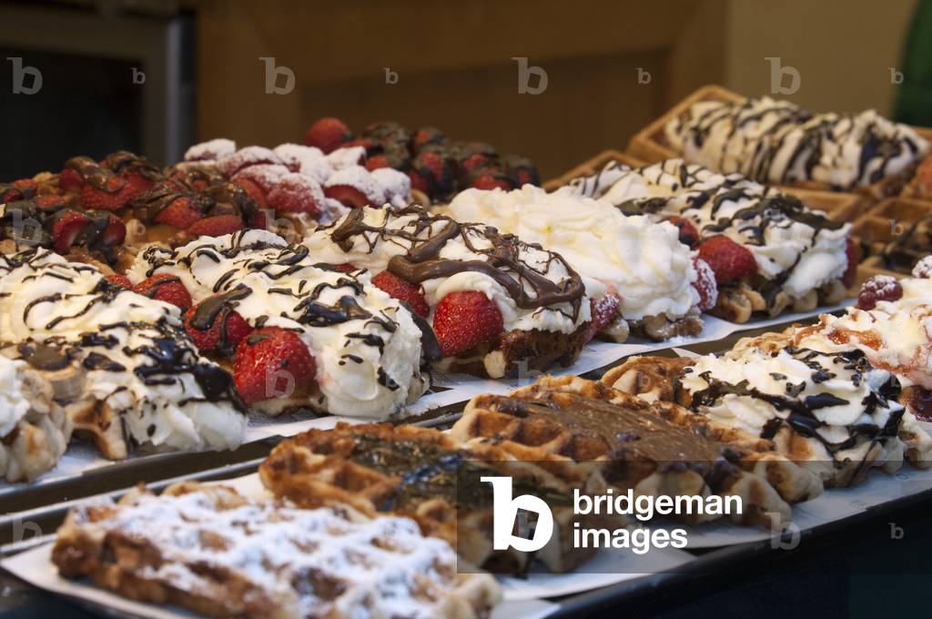 A showcase of a bakery with chocolate and cream wafles advertisement, Brussels, Belgium (photo)