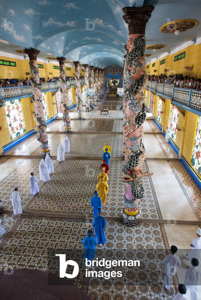 Worshipers at midday prayer in the Cao Dai temple, Tay Ninh, Vietnam (photo)