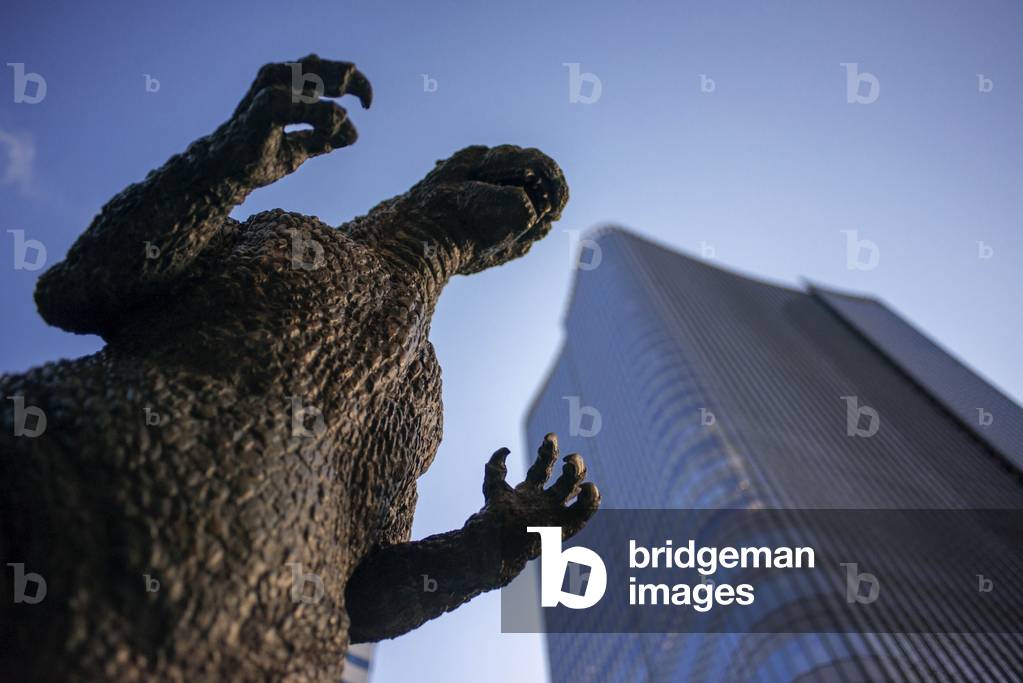 Bronze statue of Godzilla, creature movie star from 1950's, sits on a prominent pedestal in Hibiya cinema district in Tokyo, Japan, March 2020 (photo)