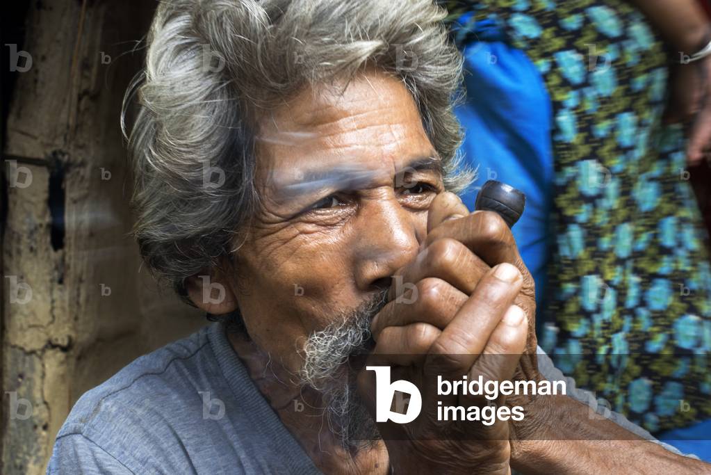 Local man smoking a joint on Shiva Day at Chitwan, Nepal (photo)